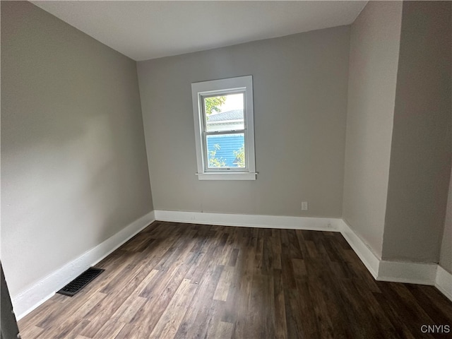 spare room with dark hardwood / wood-style floors