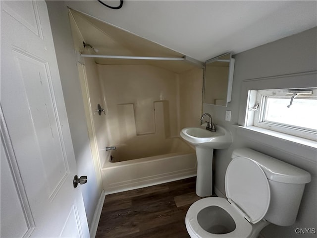 full bathroom with  shower combination, sink, wood-type flooring, and toilet