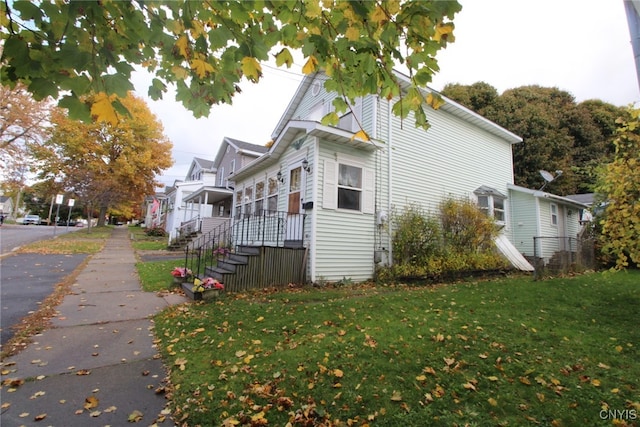 view of side of home featuring a yard