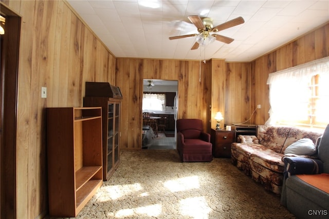 living room featuring wooden walls and plenty of natural light