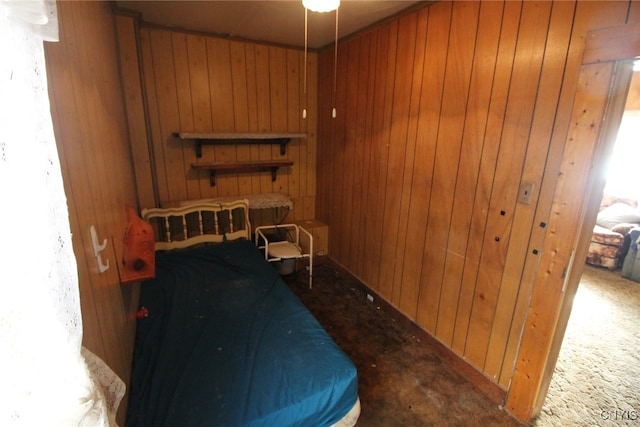 bedroom with wooden walls and carpet