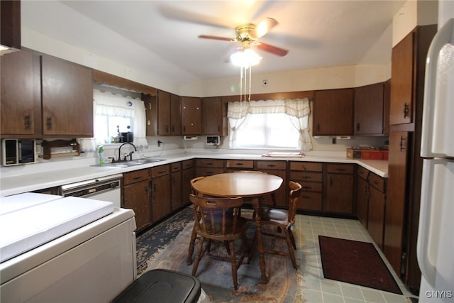 kitchen featuring dark brown cabinetry, sink, ceiling fan, and plenty of natural light