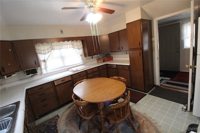 kitchen with dark brown cabinetry, light tile patterned floors, and ceiling fan