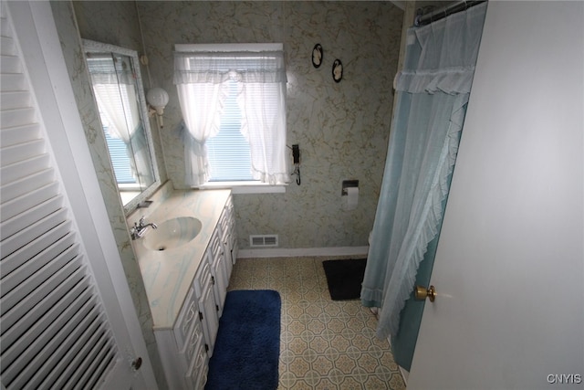 bathroom featuring vanity and a shower with shower curtain