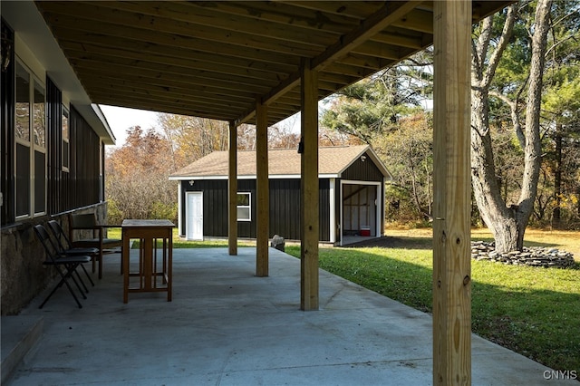 view of patio with an outdoor structure and a garage