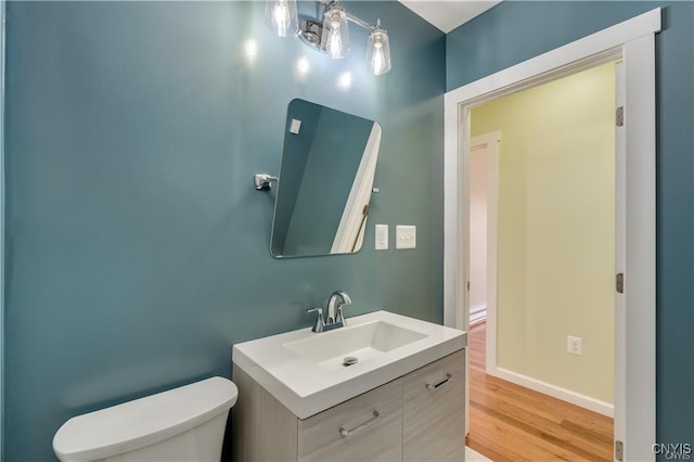 bathroom featuring hardwood / wood-style floors, vanity, and toilet