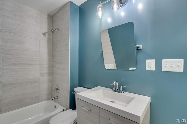 full bathroom with vanity, toilet, and tiled shower / bath