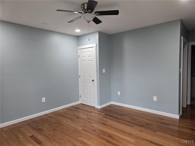 empty room featuring hardwood / wood-style floors and ceiling fan