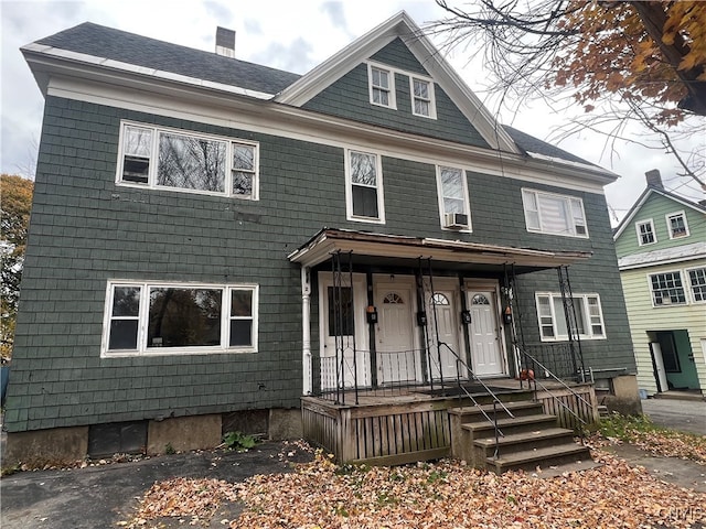 view of front facade with cooling unit and covered porch