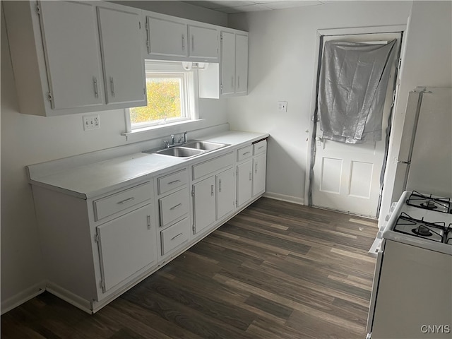 kitchen featuring sink, white cabinets, dark wood-type flooring, and white gas stove