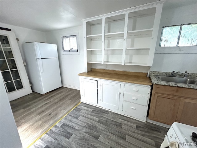 kitchen featuring dark hardwood / wood-style flooring, range, sink, and white refrigerator