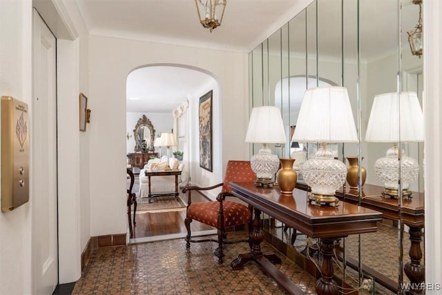 hallway with baseboards and arched walkways