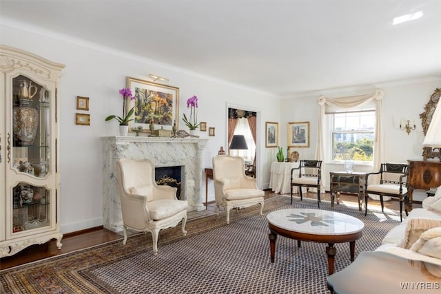 living room featuring a premium fireplace, crown molding, and dark hardwood / wood-style floors