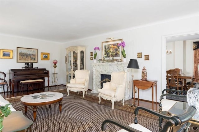 living room featuring baseboards and a fireplace