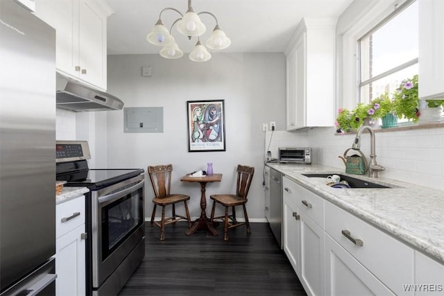 kitchen featuring white cabinets, a sink, stainless steel appliances, backsplash, and under cabinet range hood
