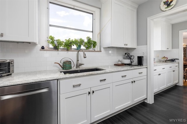 kitchen featuring dishwasher, decorative backsplash, dark hardwood / wood-style floors, sink, and white cabinetry