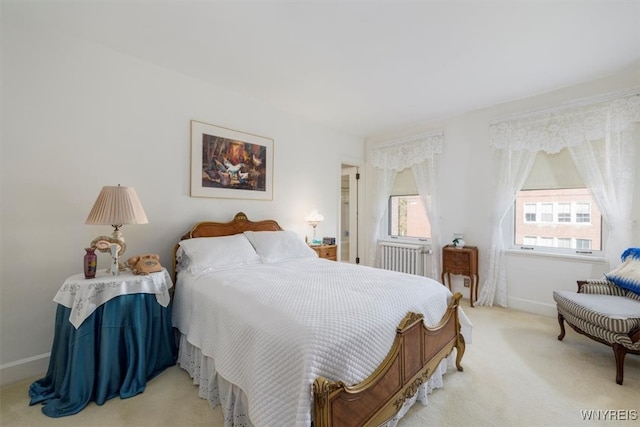 bedroom with radiator heating unit and light colored carpet