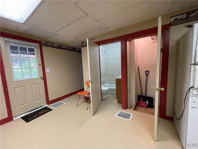 interior space with a paneled ceiling