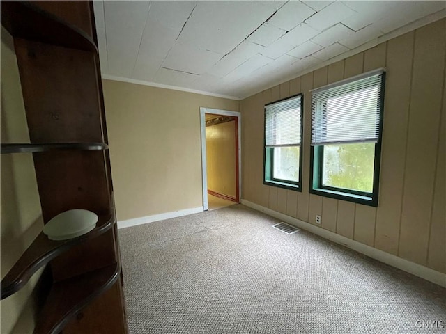 unfurnished bedroom with ornamental molding and carpet flooring