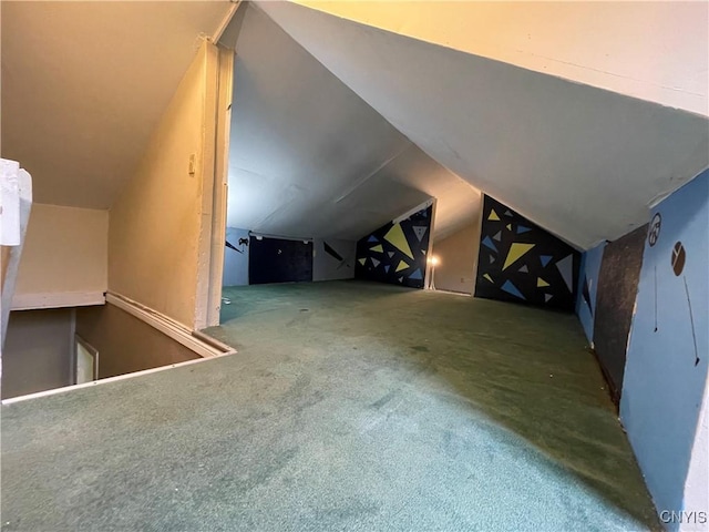 additional living space featuring carpet floors and vaulted ceiling