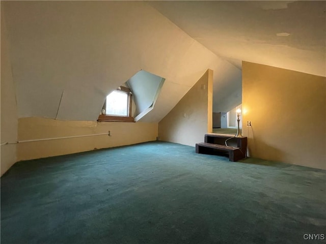 bonus room with carpet floors and vaulted ceiling