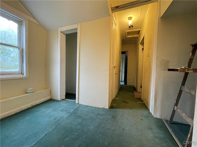 empty room featuring lofted ceiling and carpet flooring