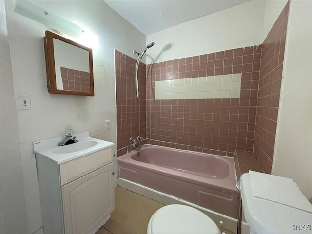 full bathroom featuring vanity, toilet, and tiled shower / bath combo