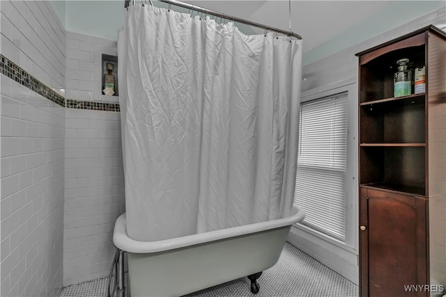 bathroom featuring tile patterned floors, separate shower and tub, and tile walls