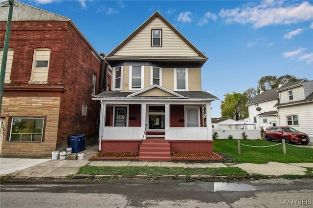 view of property featuring a front yard and a porch