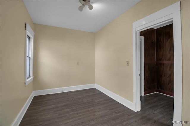 spare room with dark hardwood / wood-style flooring