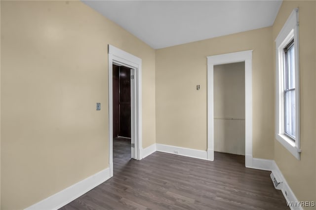 unfurnished room featuring dark hardwood / wood-style flooring