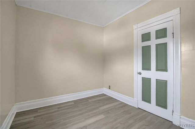 spare room featuring light hardwood / wood-style floors and crown molding