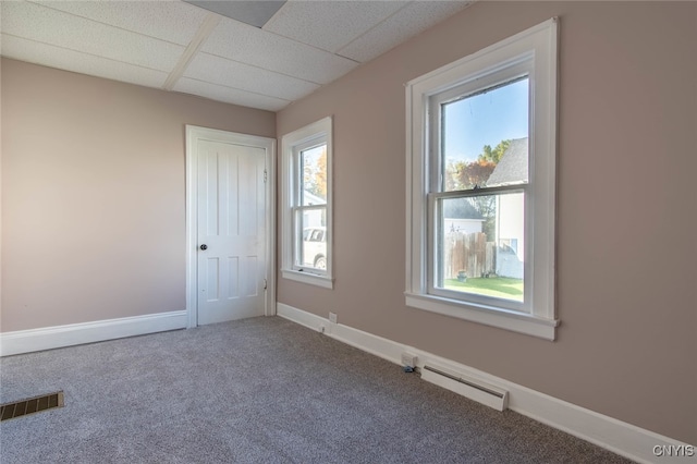 unfurnished room featuring a paneled ceiling, a baseboard radiator, and carpet