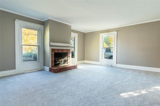 unfurnished living room with crown molding, carpet floors, plenty of natural light, and a brick fireplace