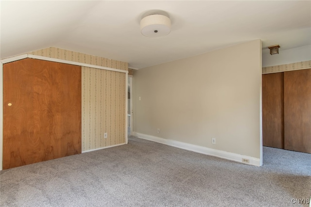 interior space with lofted ceiling, carpet flooring, and a closet