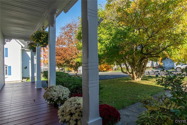 deck featuring a yard and covered porch