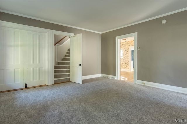 unfurnished living room featuring ornamental molding and carpet flooring