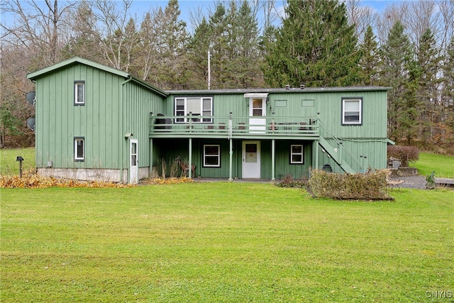 back of property with a deck and a yard