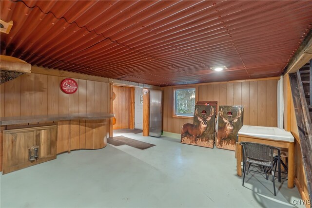 basement featuring wooden walls