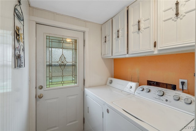 clothes washing area featuring cabinets and independent washer and dryer