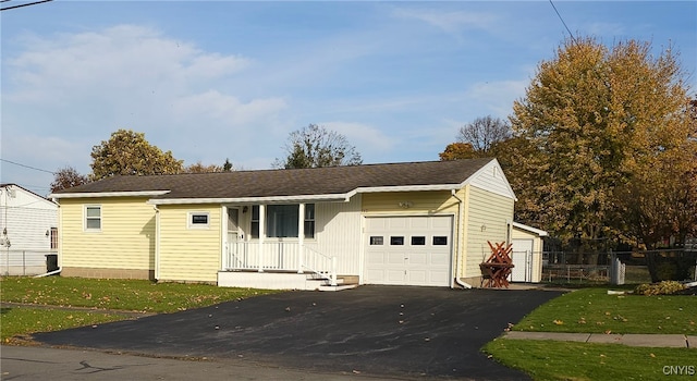 ranch-style home with a front lawn and a garage