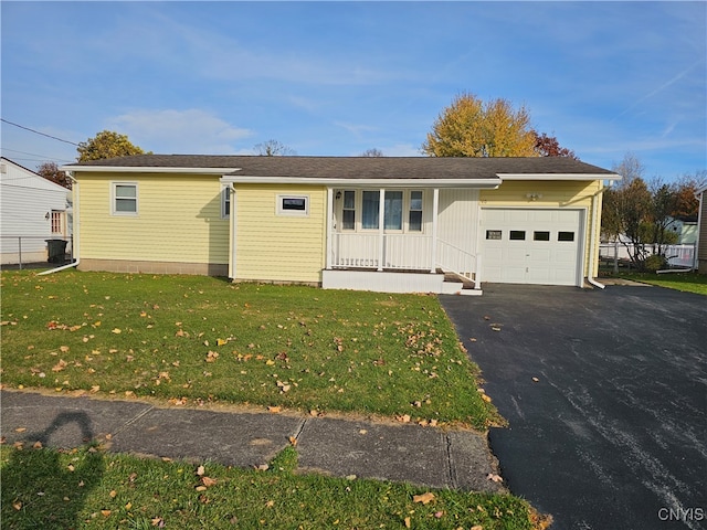 view of front of property with covered porch, a front yard, and a garage