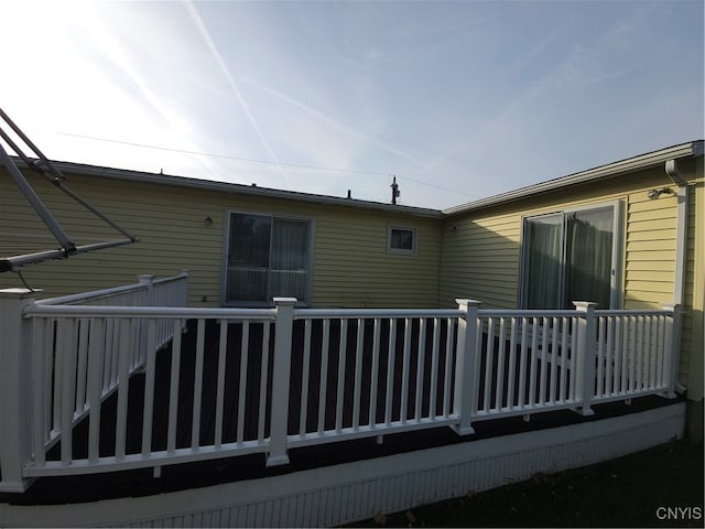 rear view of property featuring a deck