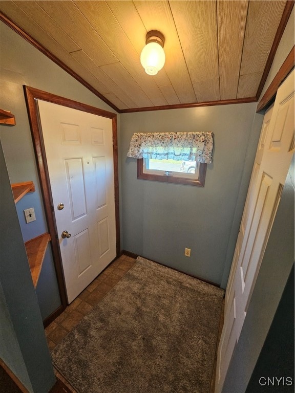 tiled entryway with crown molding, vaulted ceiling, and wood ceiling