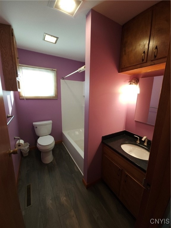 full bathroom with vanity, toilet, washtub / shower combination, and hardwood / wood-style floors