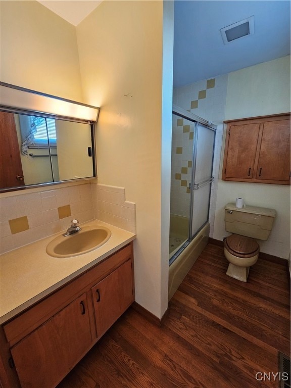 bathroom with toilet, walk in shower, vanity, and wood-type flooring