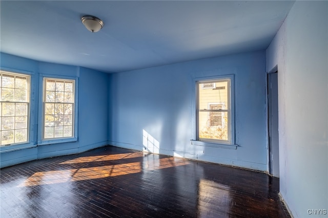 spare room with dark wood-type flooring