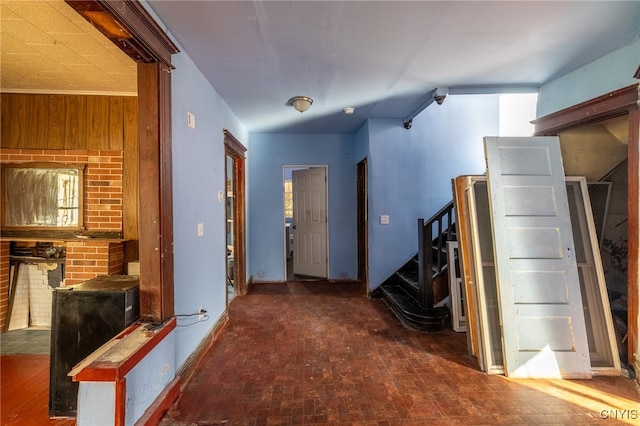 corridor with a healthy amount of sunlight and wood walls