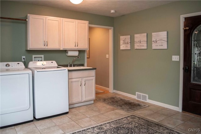 laundry area featuring cabinets, sink, light tile patterned floors, and independent washer and dryer