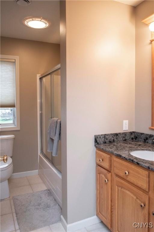 full bathroom with vanity, tile patterned floors, shower / bath combination with glass door, and toilet